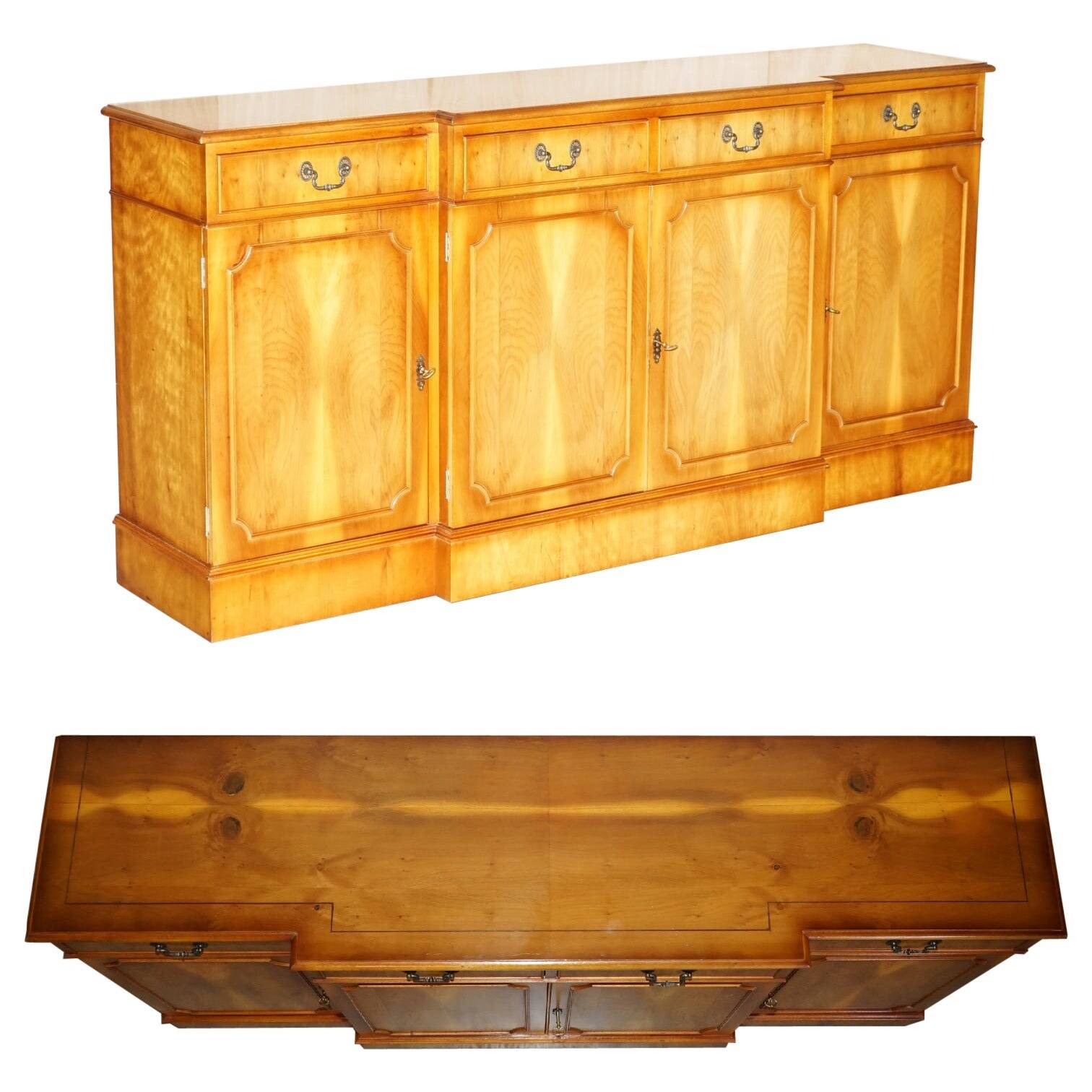 Vintage buffet made of mottled yew wood with three doors and four drawers.