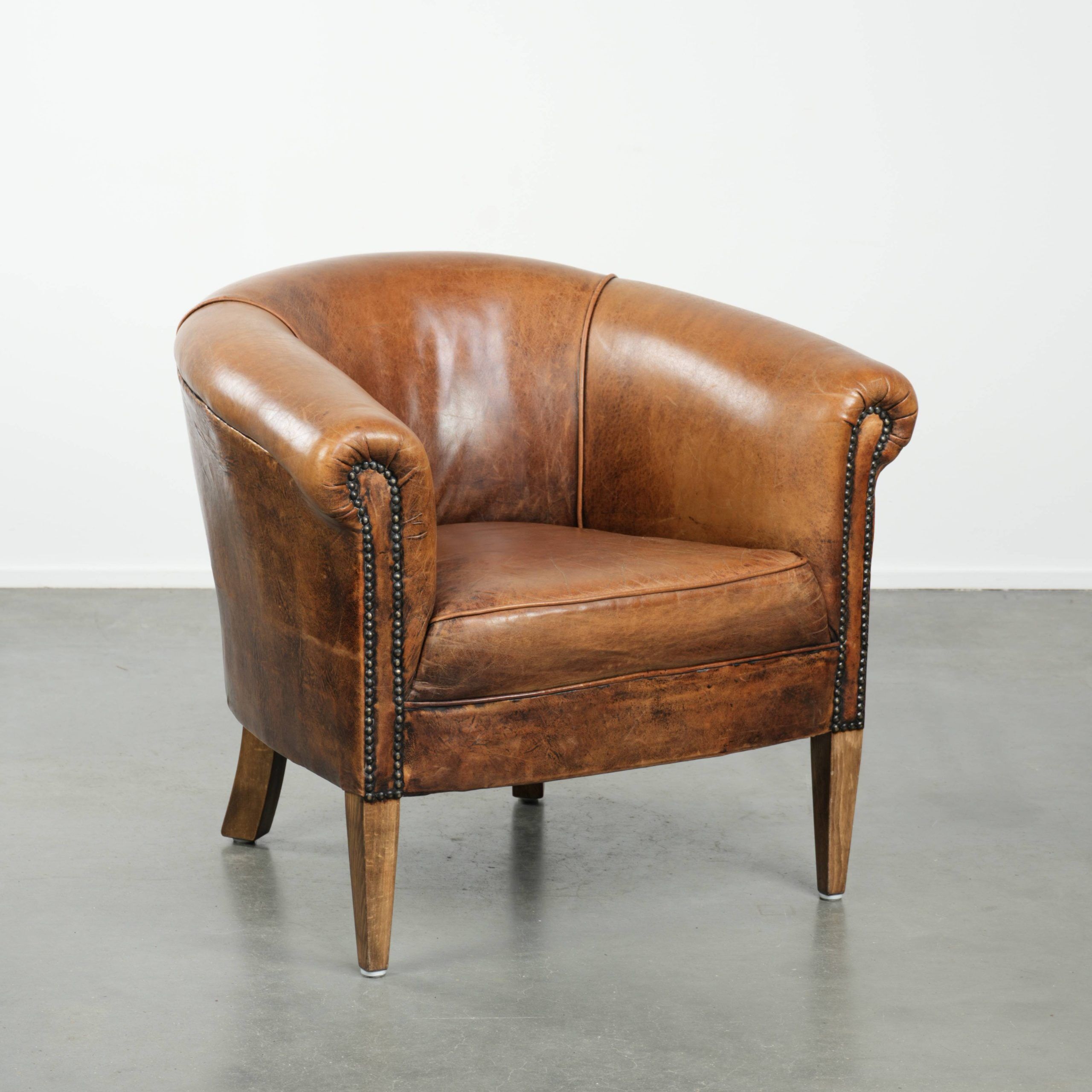 Vintage sheepskin club armchair in a subtle size with warm colours