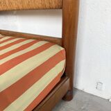 Brutalist style bed with chain and straw