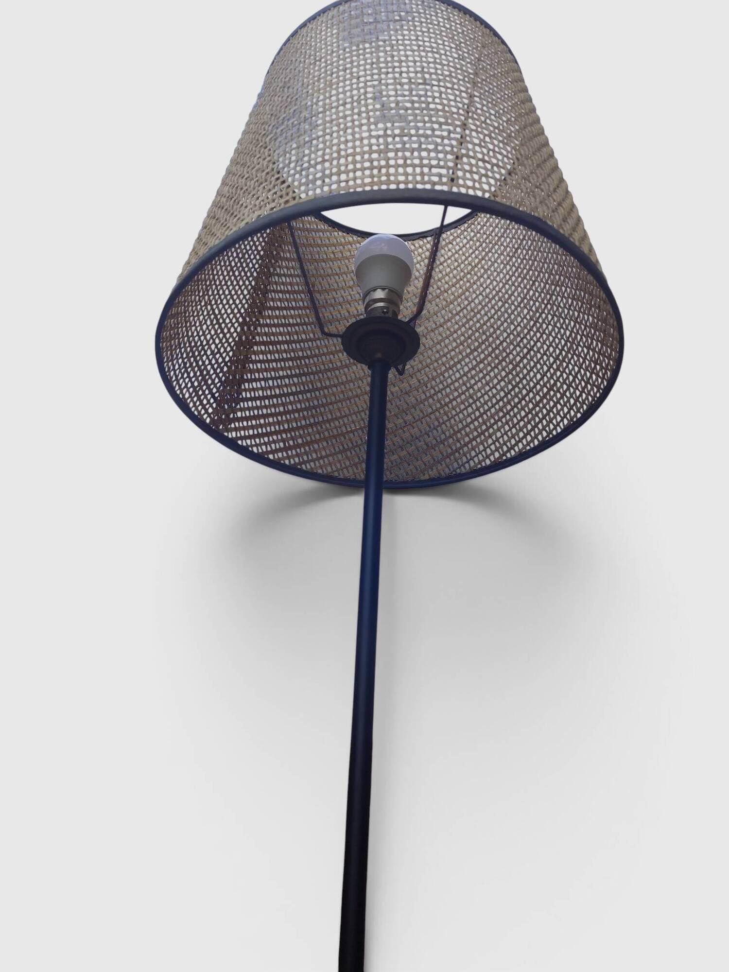 Modernist tripod floor lamp in black metal and cane from the 1950s/1960s.