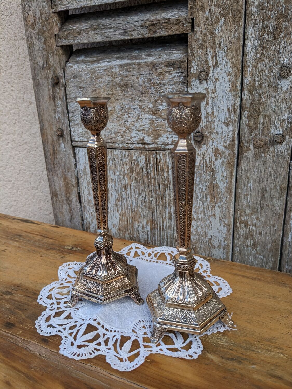 Pair of chiseled metal candle holders