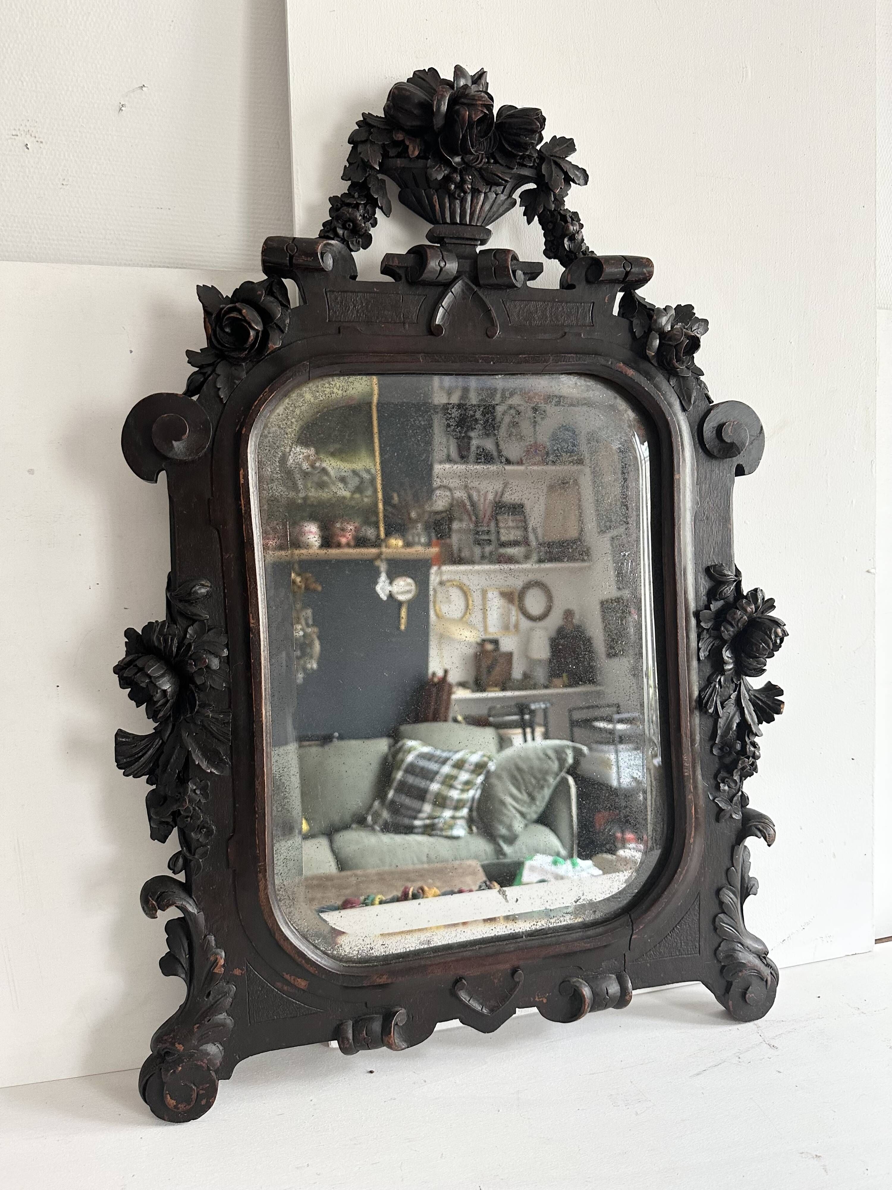 Napoleon III mirror in carved blackened wood, 19th century