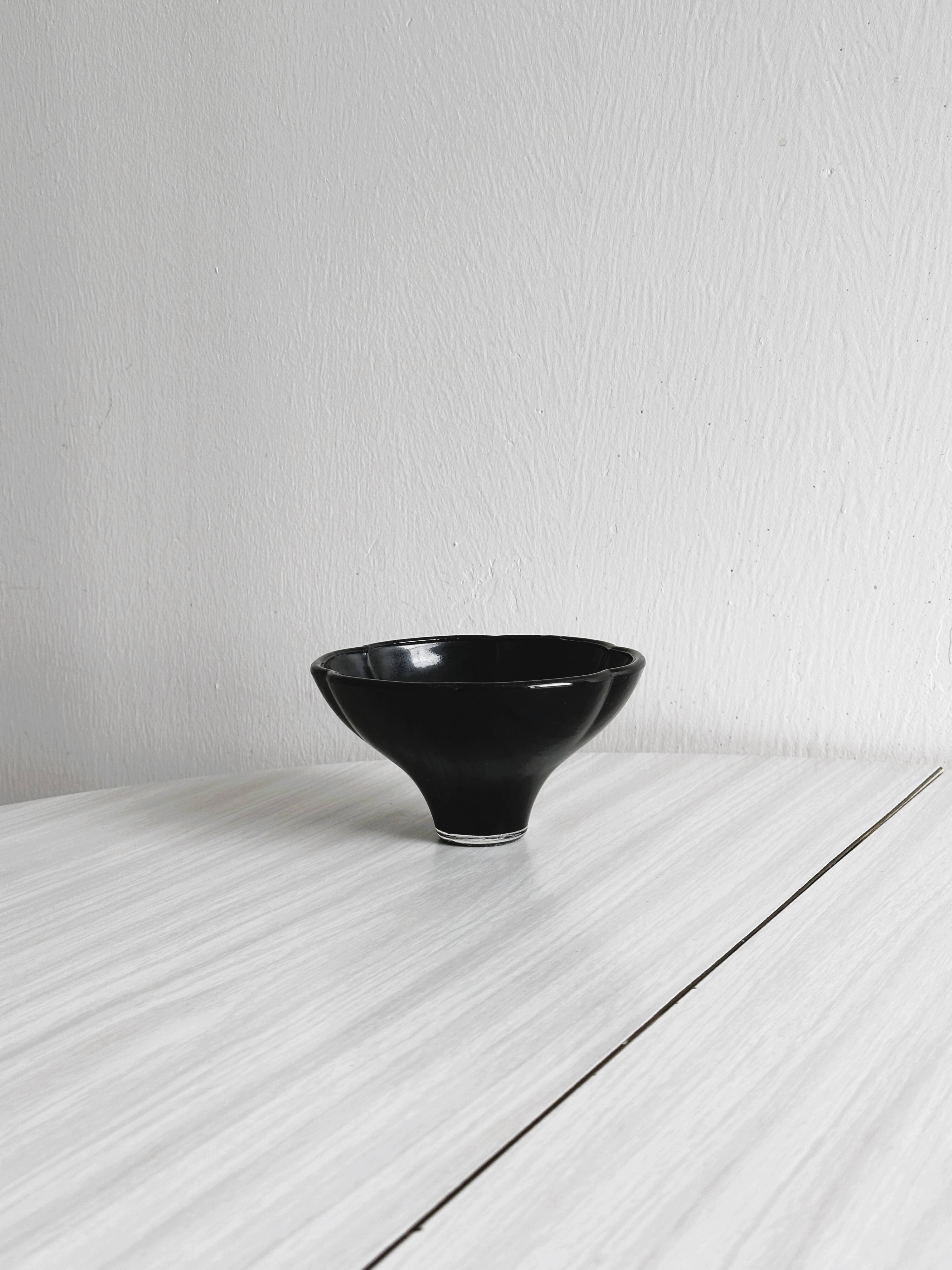 Small black glass cup