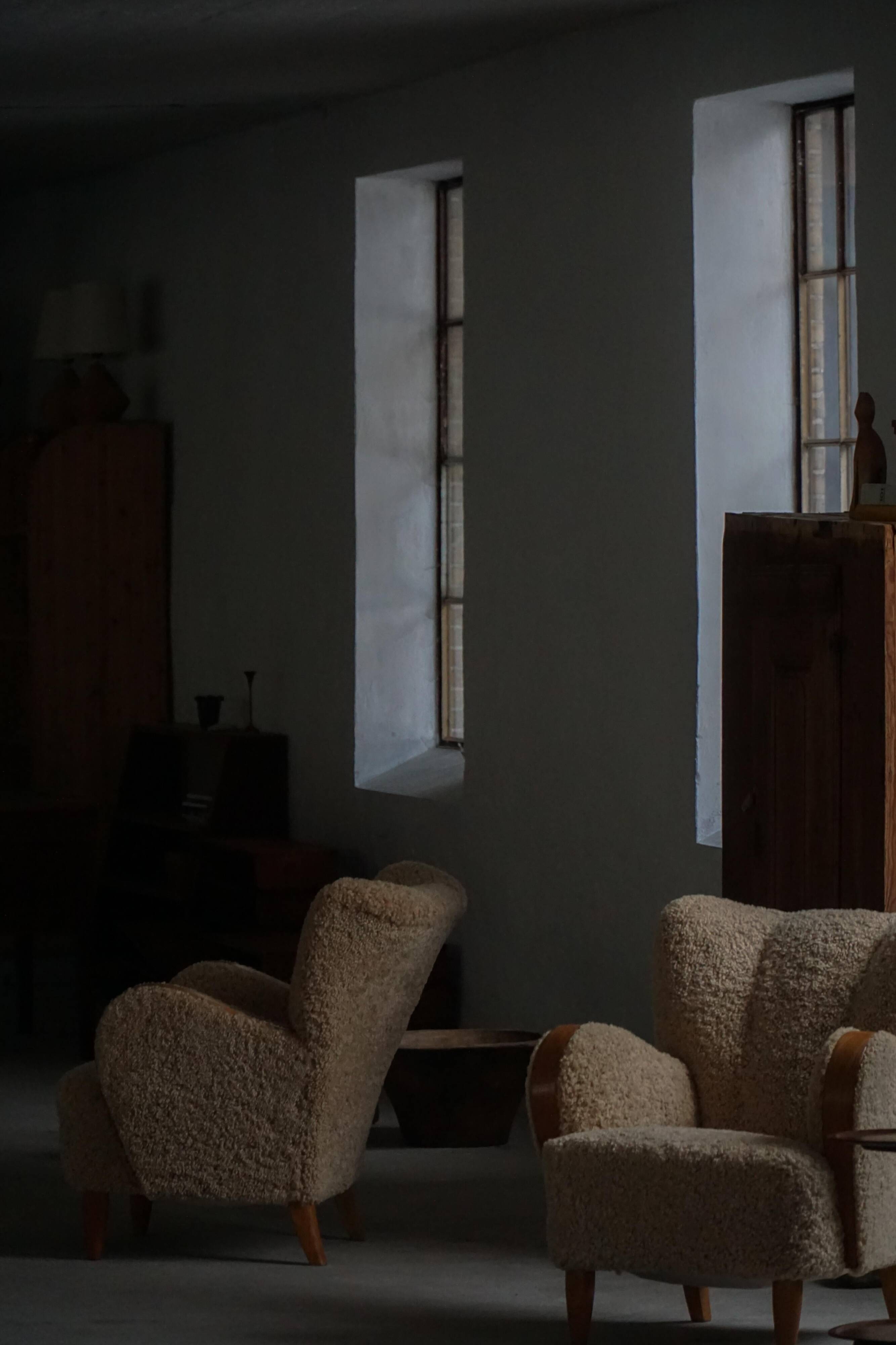 Pair of Danish Art Deco modern lounge chairs in sheepskin with lambswool and elm, 1940s.