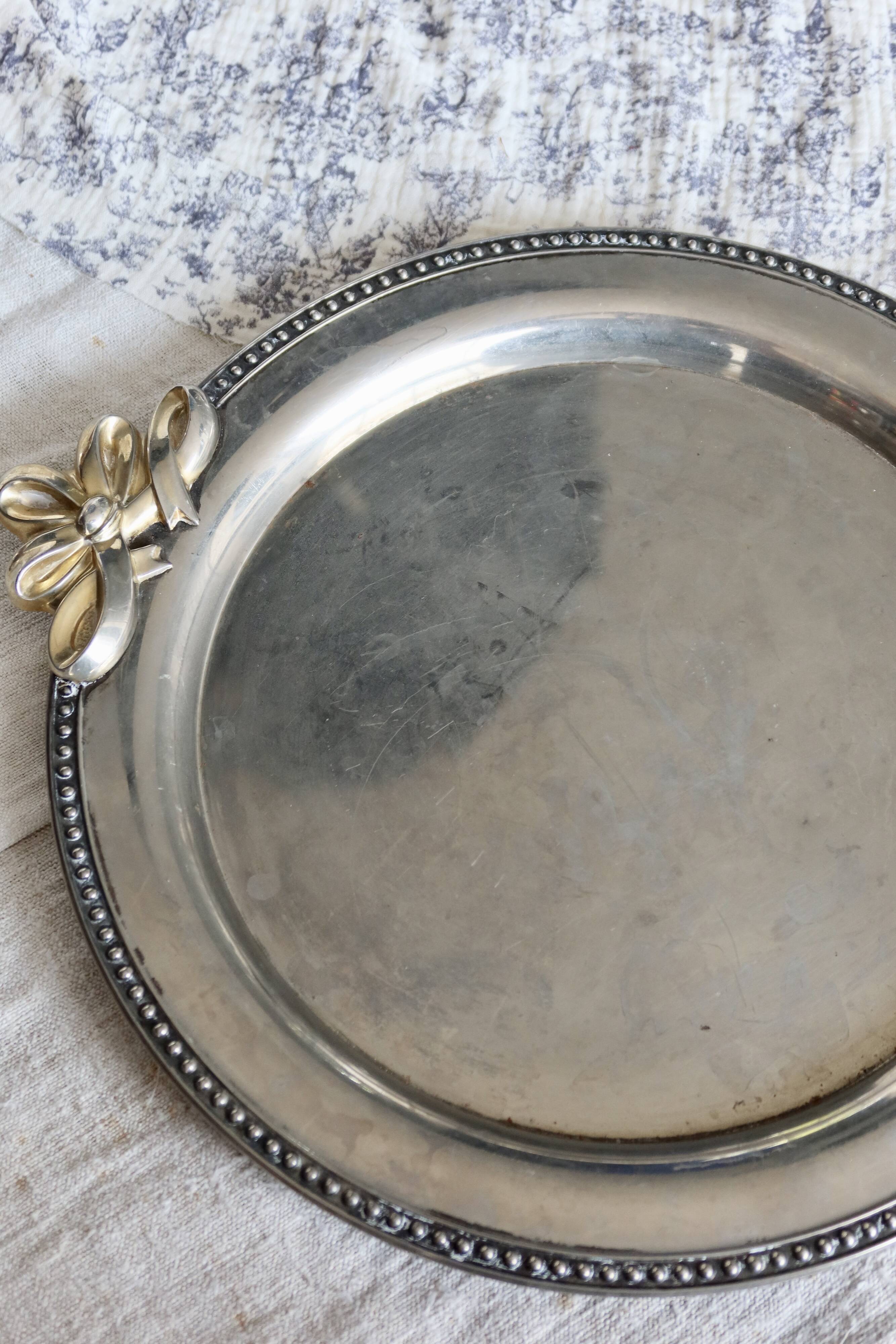 Vintage round silver metal serving tray with gold knot handles