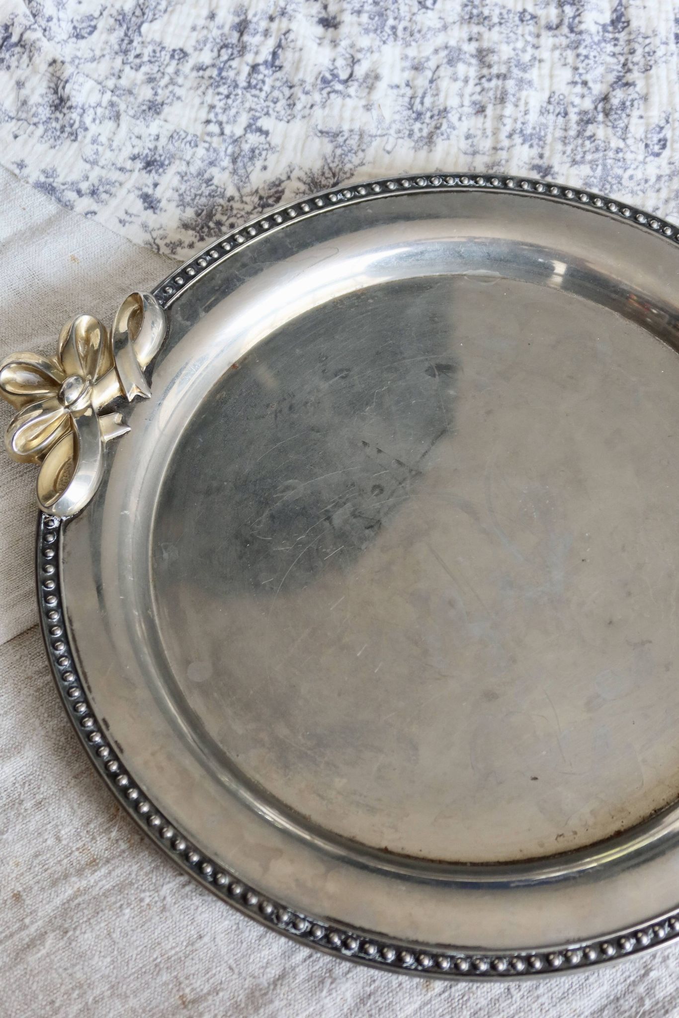 Vintage round silver metal serving tray with gold knot handles