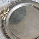 Vintage round silver metal serving tray with gold knot handles