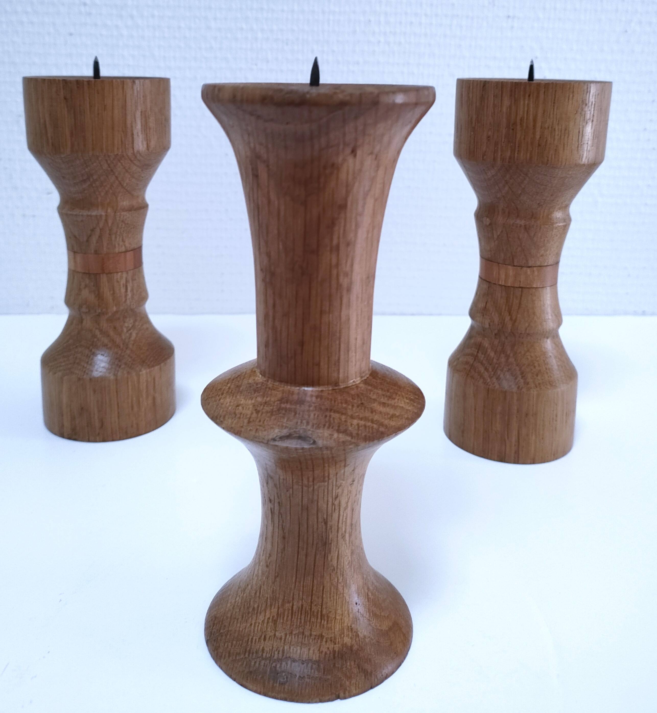 Three vintage patinated solid wood candlesticks