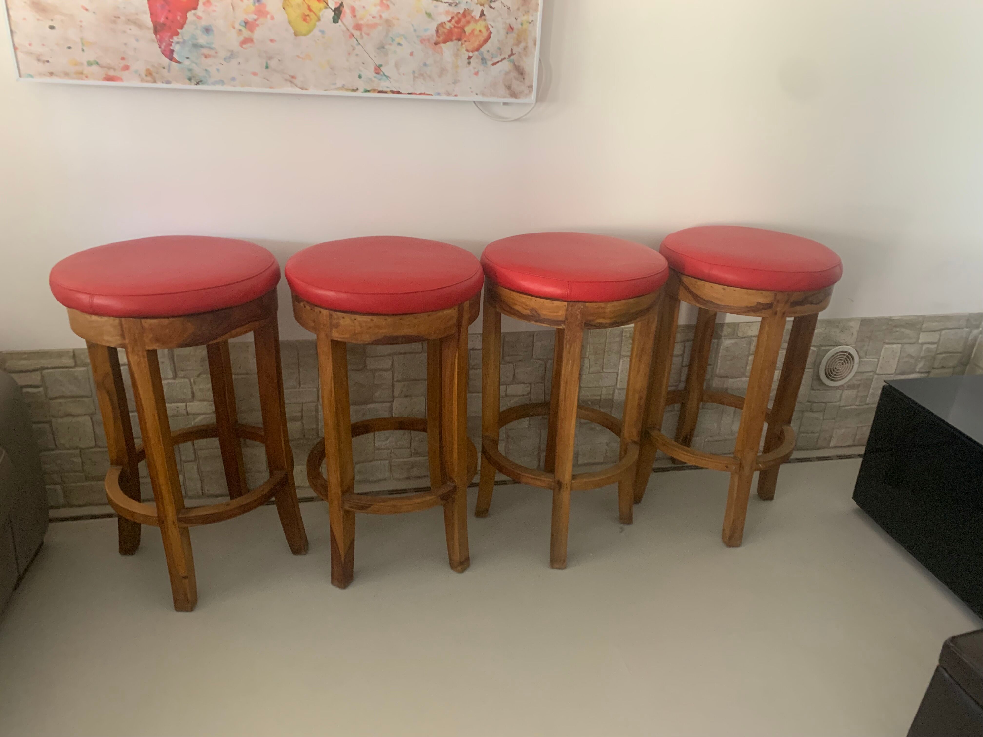 Set of 4 bar stools in solid exotic wood and red leather.