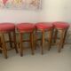 Set of 4 bar stools in solid exotic wood and red leather.