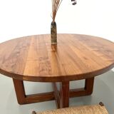 Modernist round table in solid elm, crossed legs.