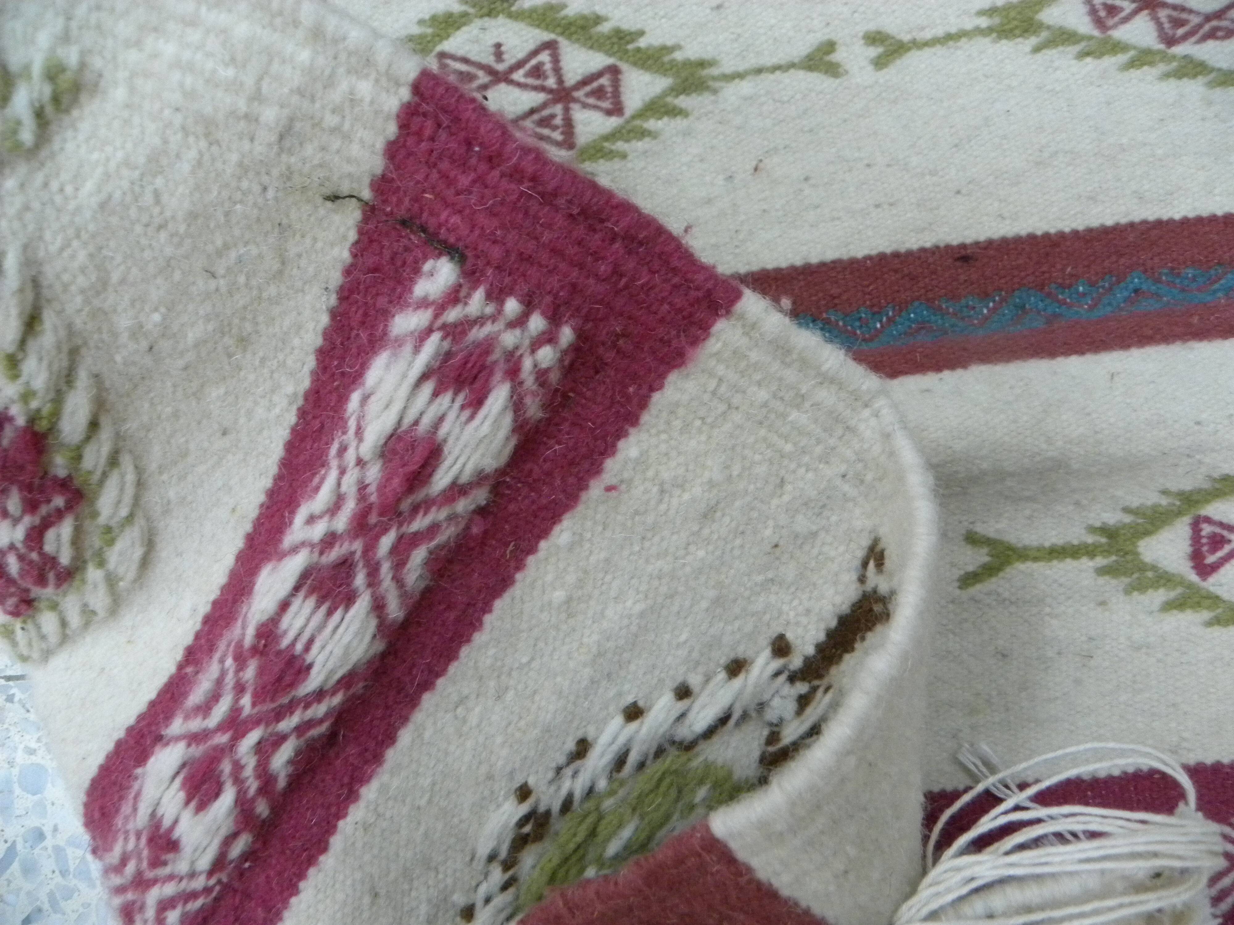 Tribal bohemian kilim rug with geometric pattern in wool.