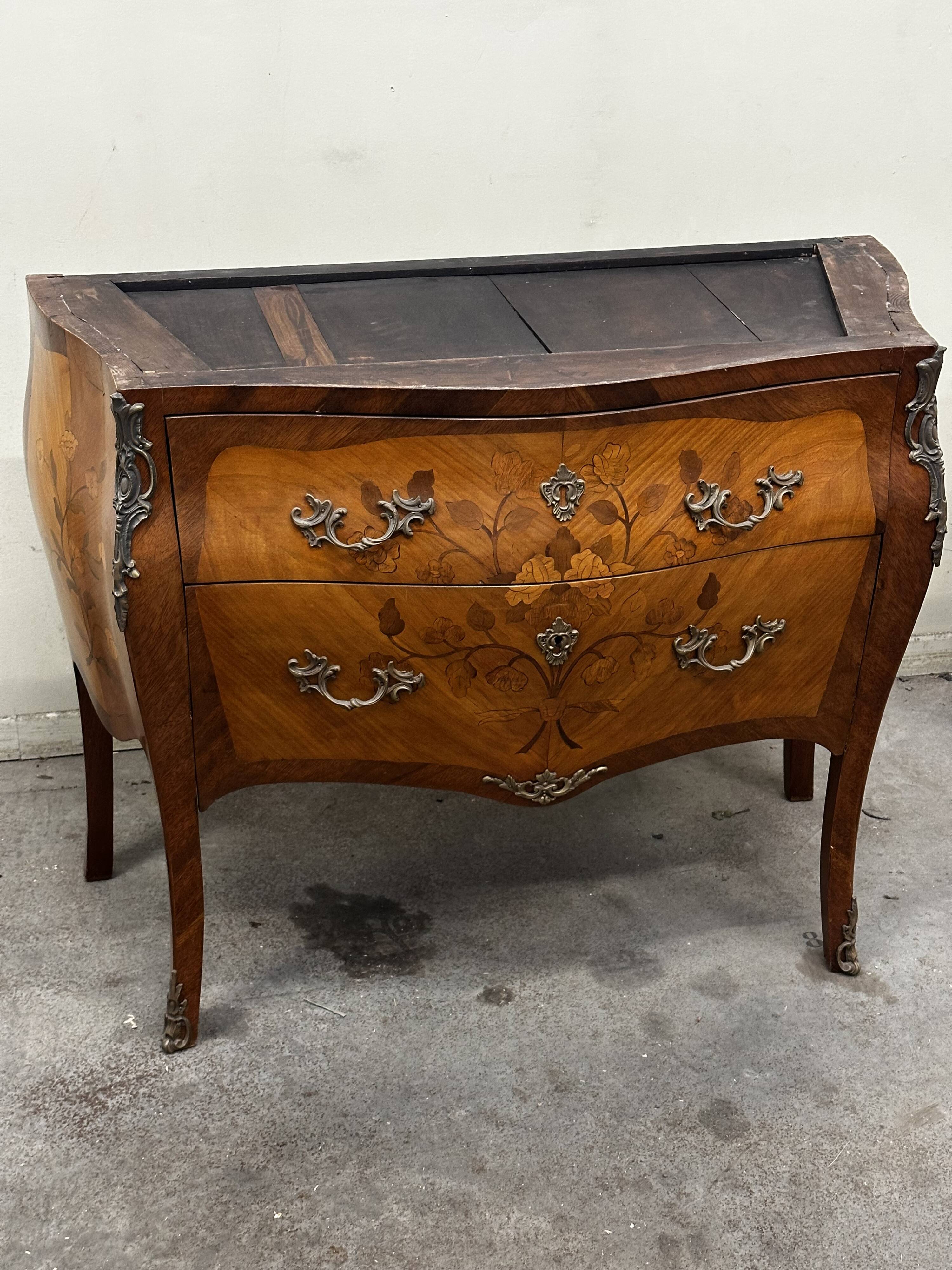 Curved and inlaid Louis XV style chest of drawers