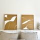 Diptych relief panels with a brown camel and cream background.