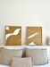 Diptych relief panels with a brown camel and cream background.