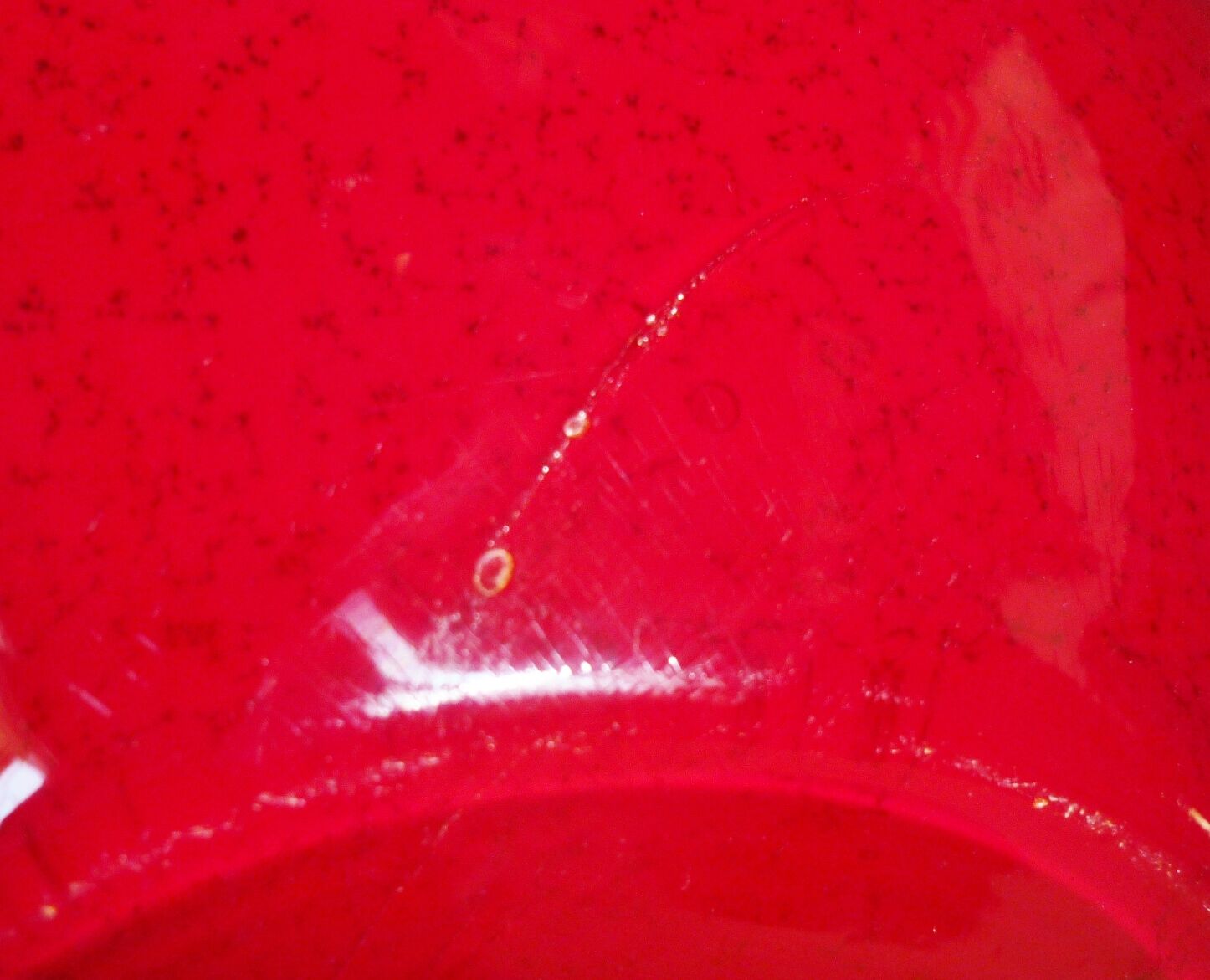 Pot-bellied, art deco vase in speckled ruby red multi-layered glass, white interior