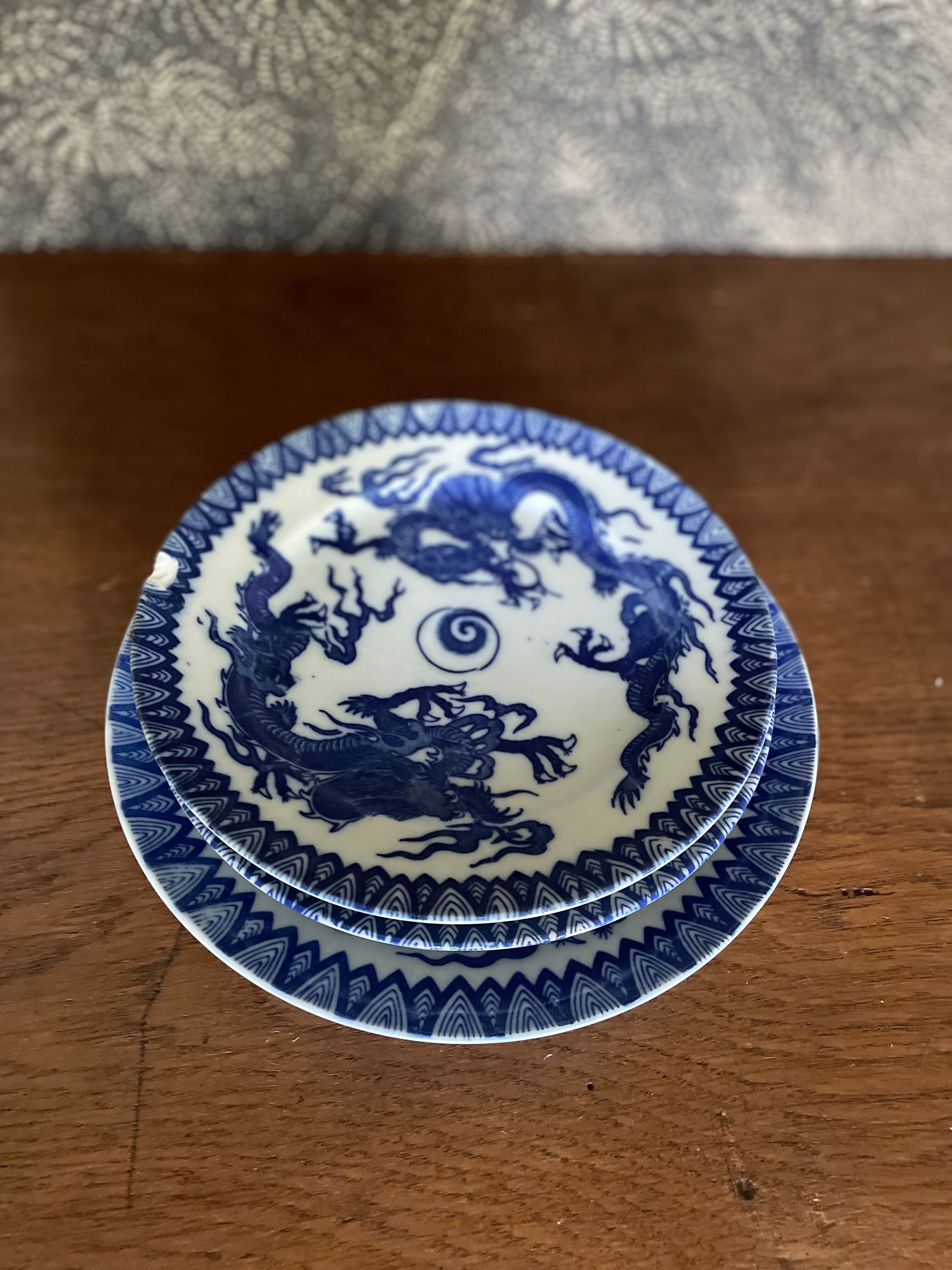 Asian porcelain plates decorated with blue dragons
