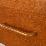 Vintage 1960s chest of drawers with covered handles.