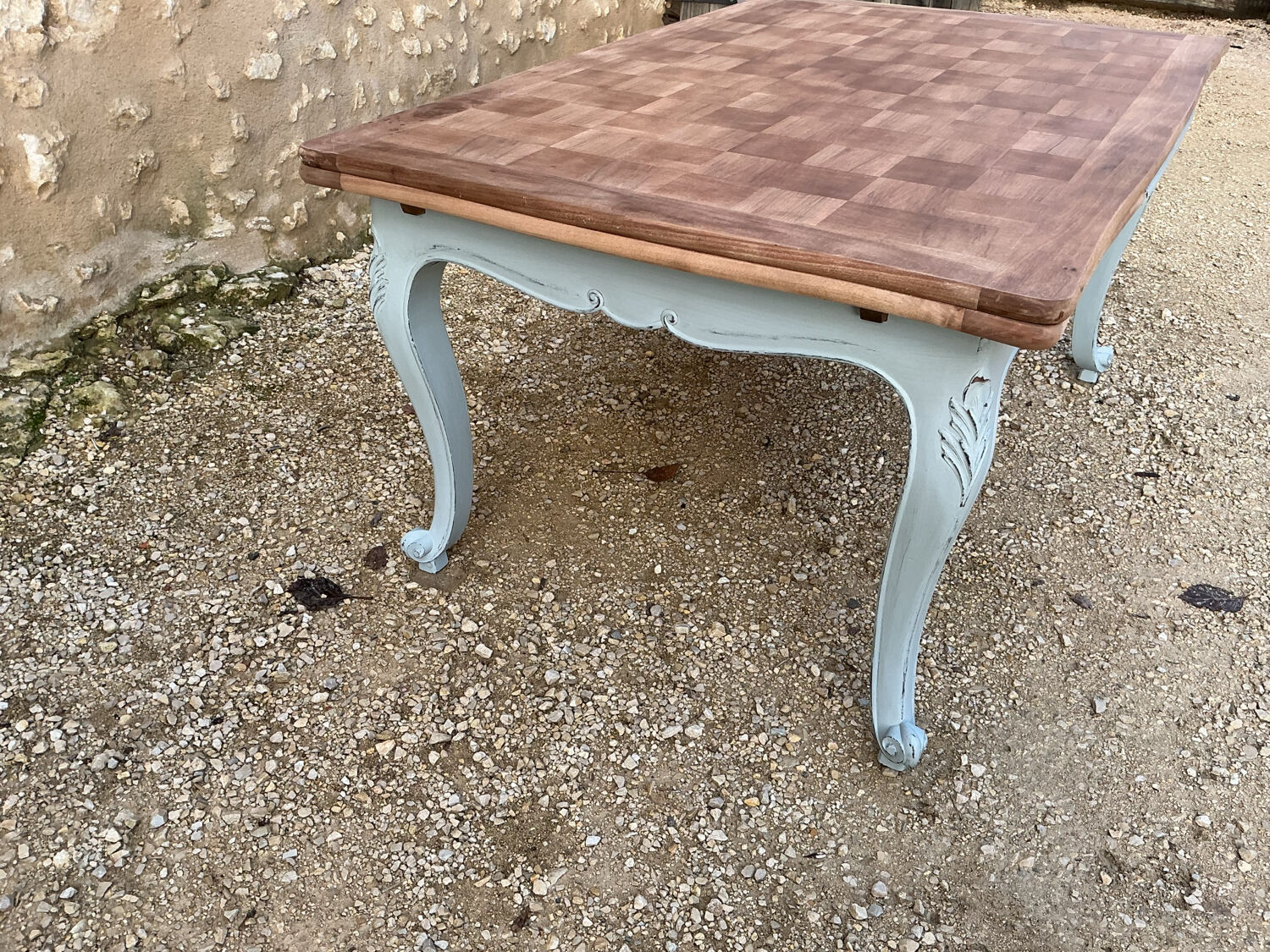 Louis XV style walnut table with a natural wood top.