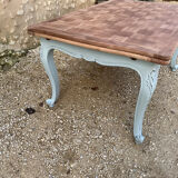 Louis XV style walnut table with a natural wood top.