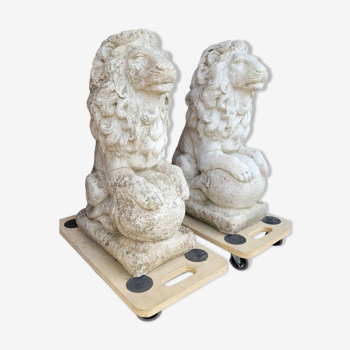 Pair of seated lion statues in old reconstituted stone