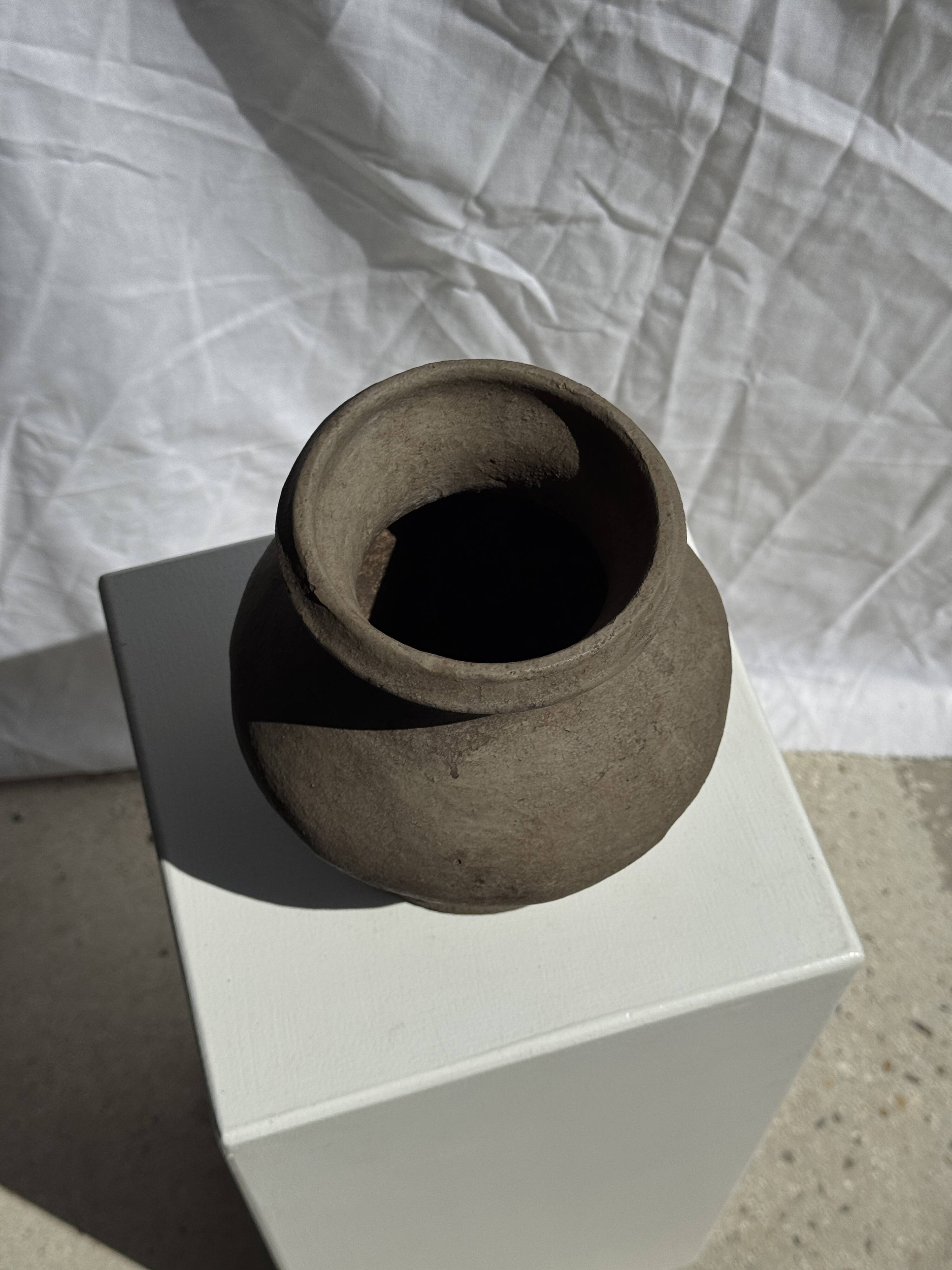 Small brutalist handcrafted terracotta vase with a pedestal, Indonesian, H19 D17.