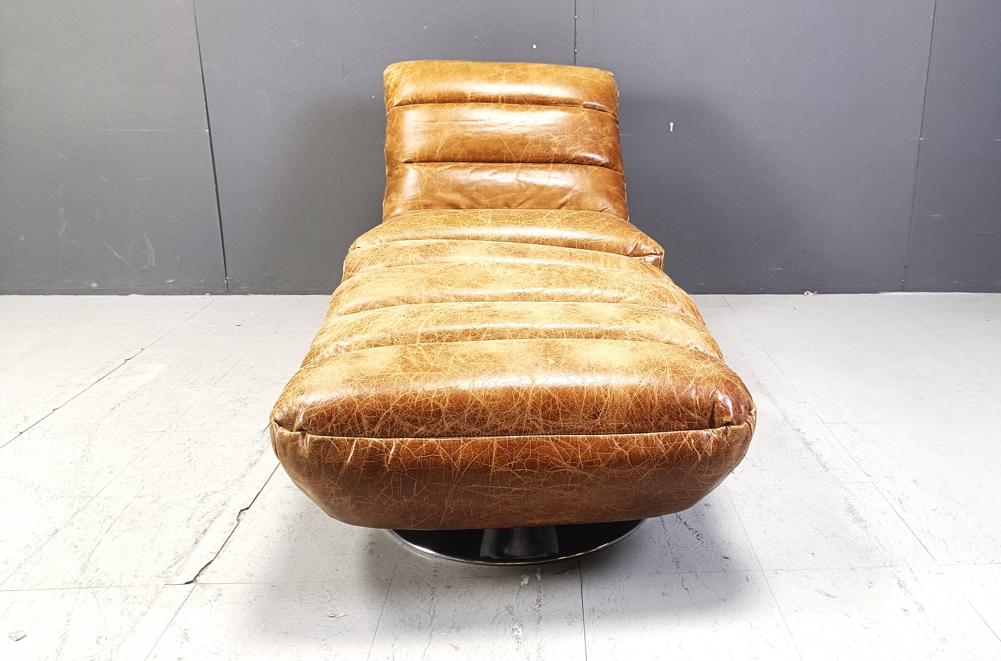 Vintage leather swivel chair with stool, 1970s