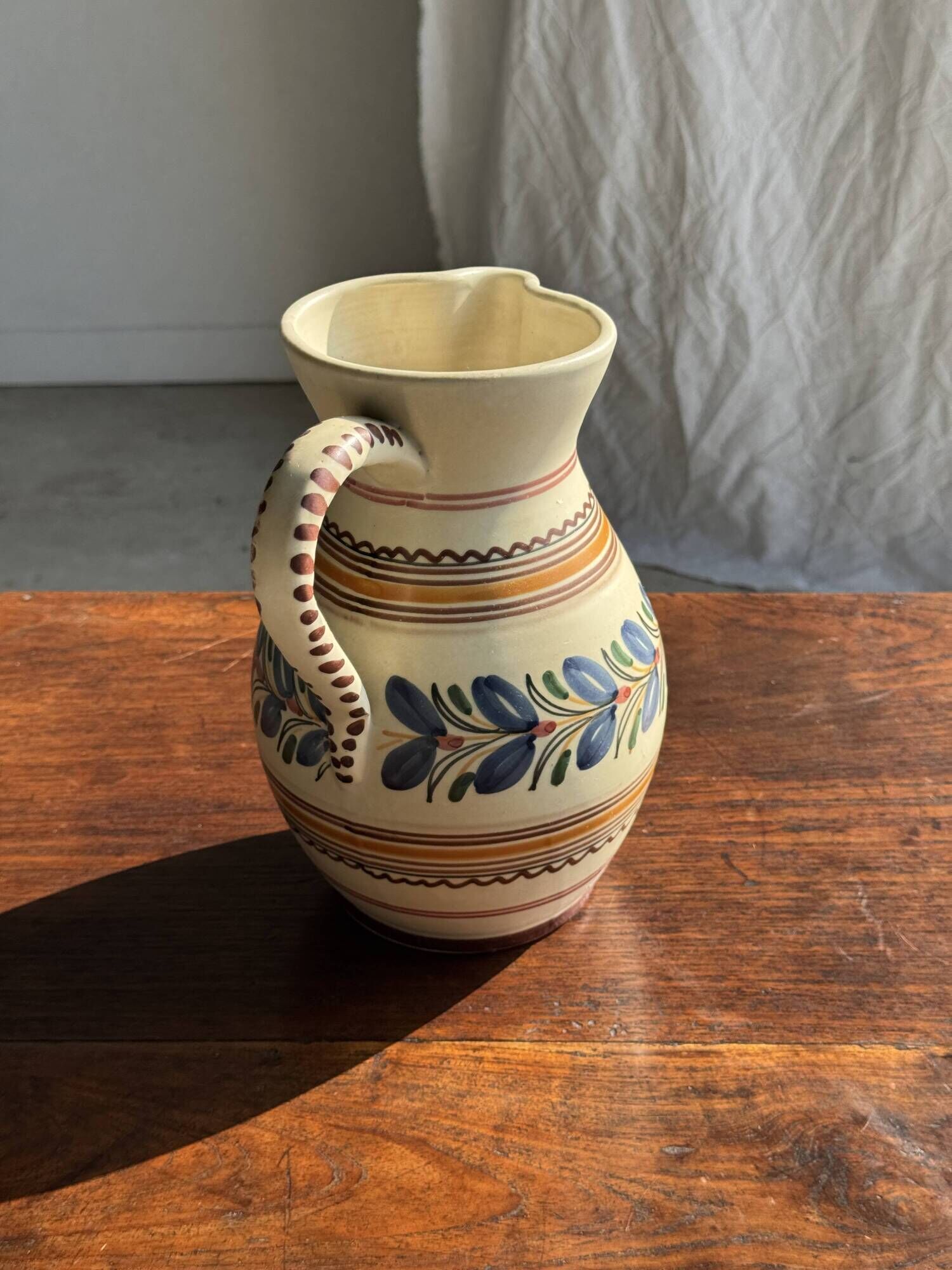 Beige carafe with stylized blue flower friezes