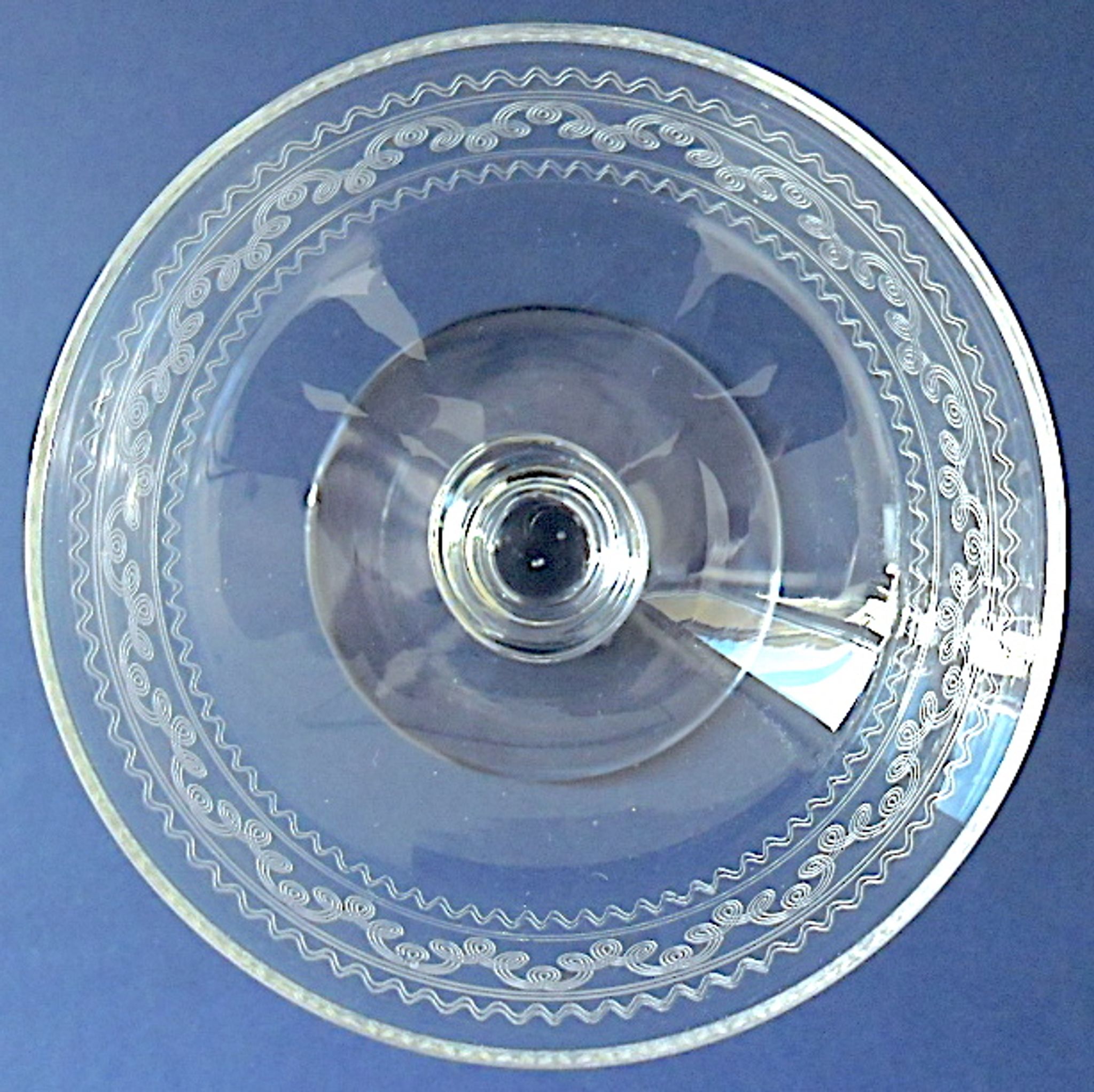 Suite of six champagne glasses on foot in engraved colorless crystal