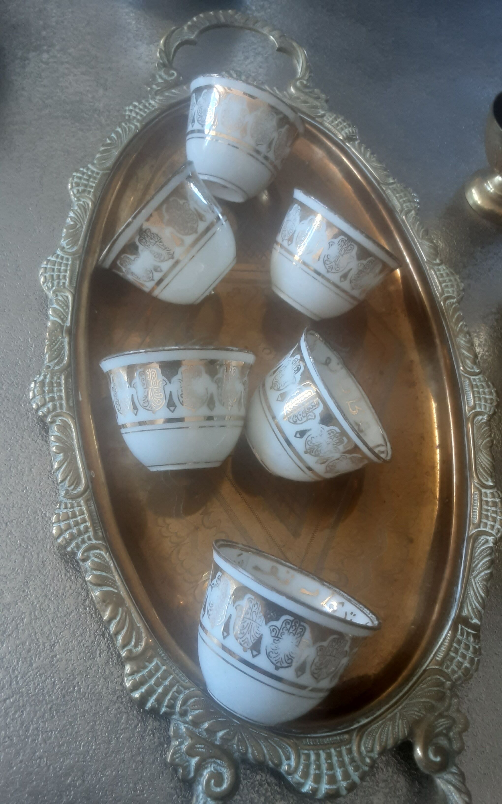 Old service porcelain brass cups