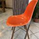 A vintage 70s Eames Herman Miller DSW Fiber Red Orange Dowel Walnut Chair