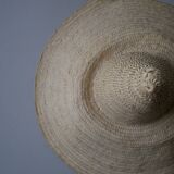 Hand-woven wicker straw hat, artisanal production, decorative object, bohemian ethnic countryside