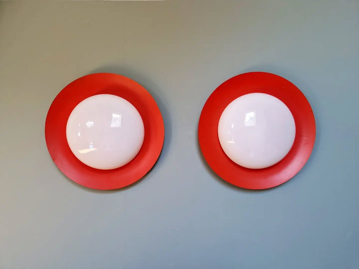 Pair of XXL Space Age wall sconces, orange lacquered metal and opaline, 1960.