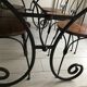 Wrought iron table with wooden top and 6 chairs