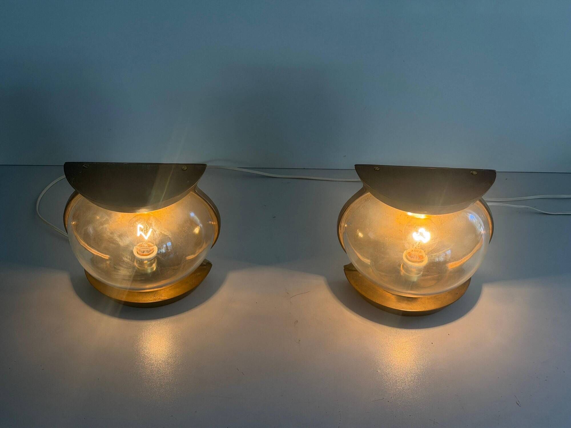Pair of bronze and glass wall lights from the mid-century, 1960, Italy.