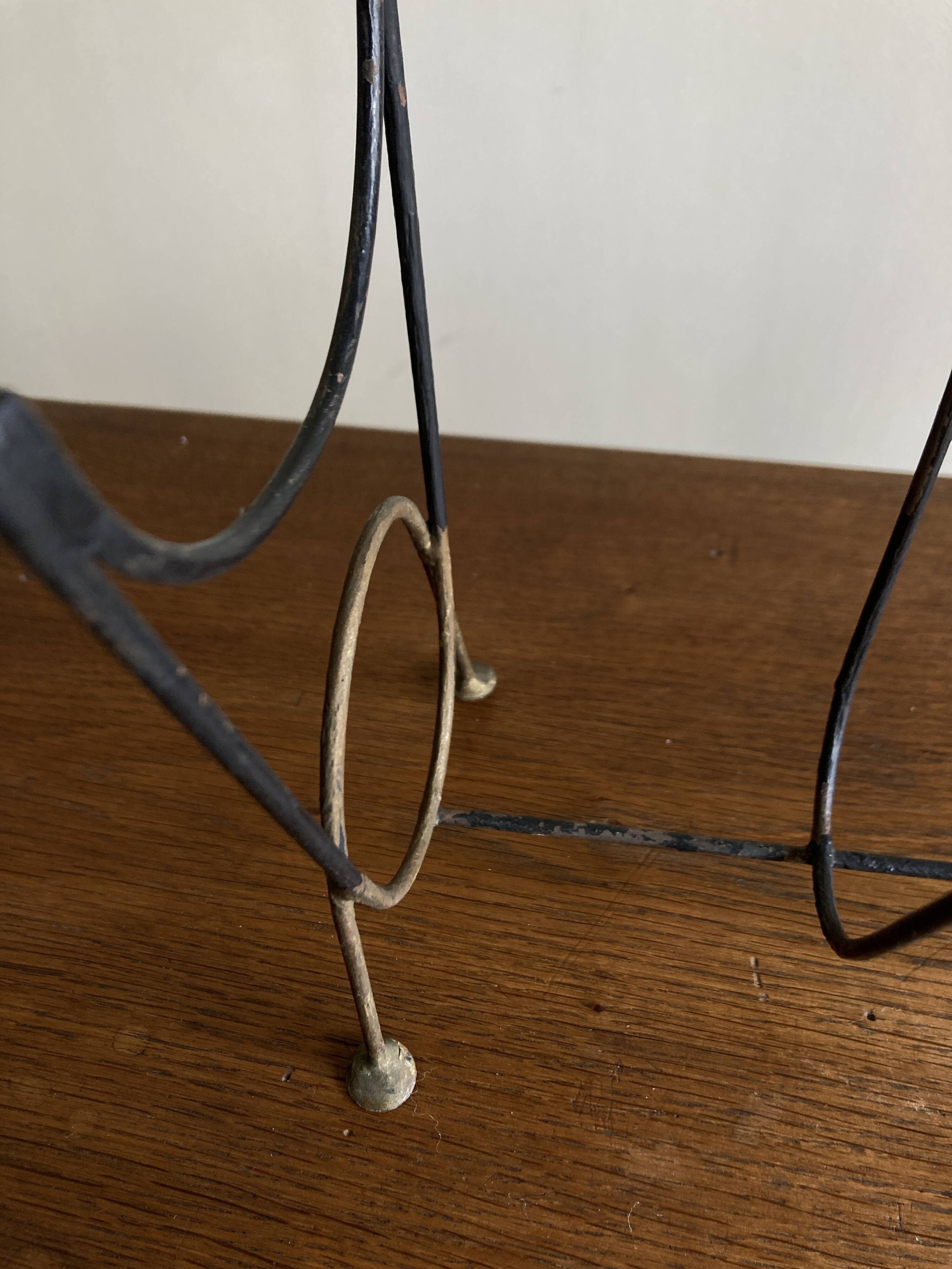 Mid-century poetic magazine rack in black metal