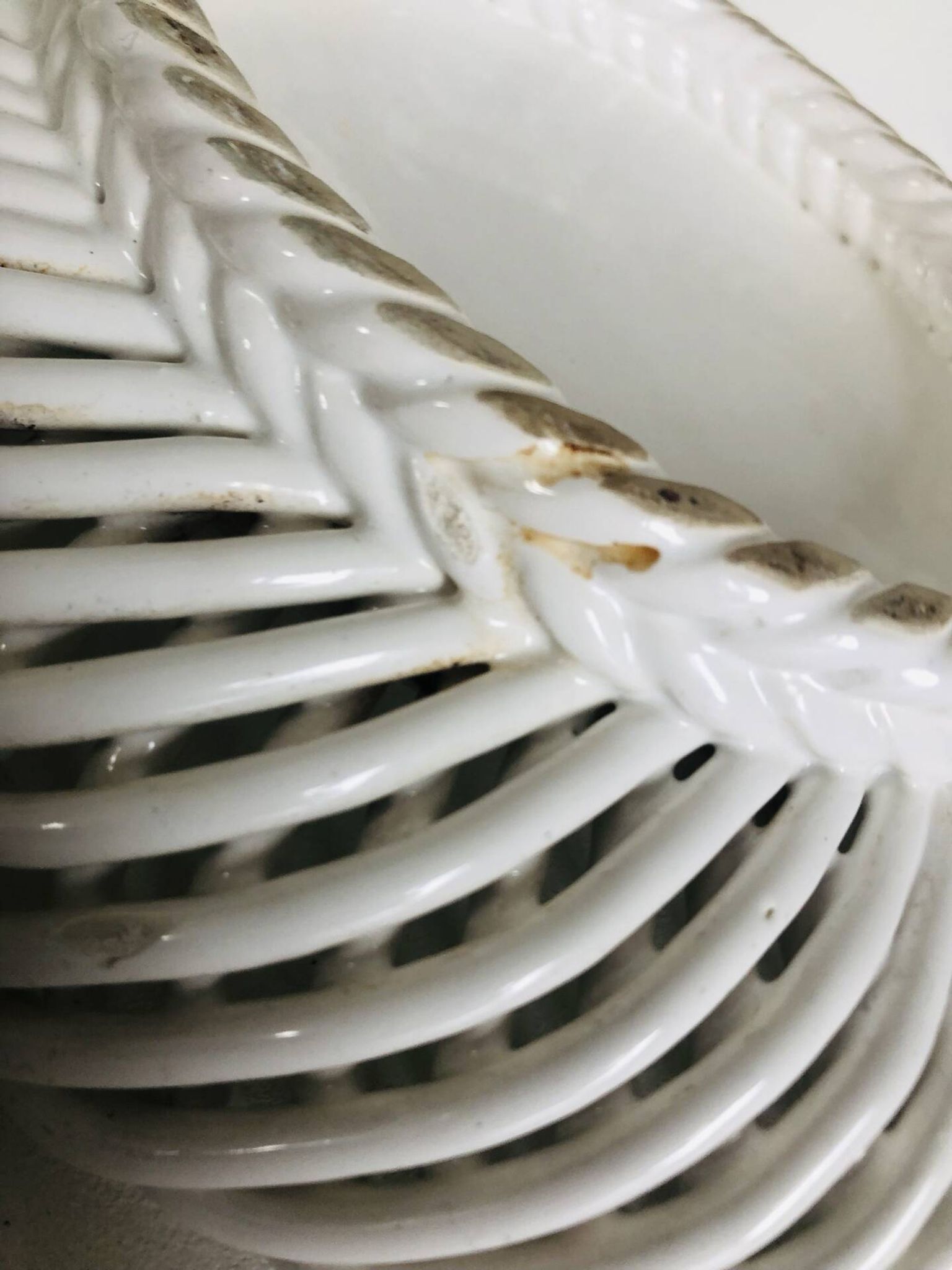Covered basket in white woven ceramic and fruit slip.