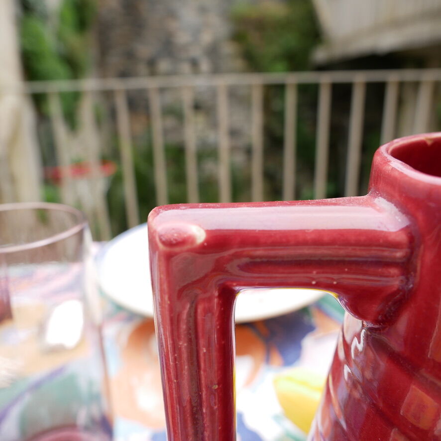 Burgundy/red ceramic pitcher
