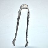 Rocaille sugar tongs in silver metal with lion claw medallion