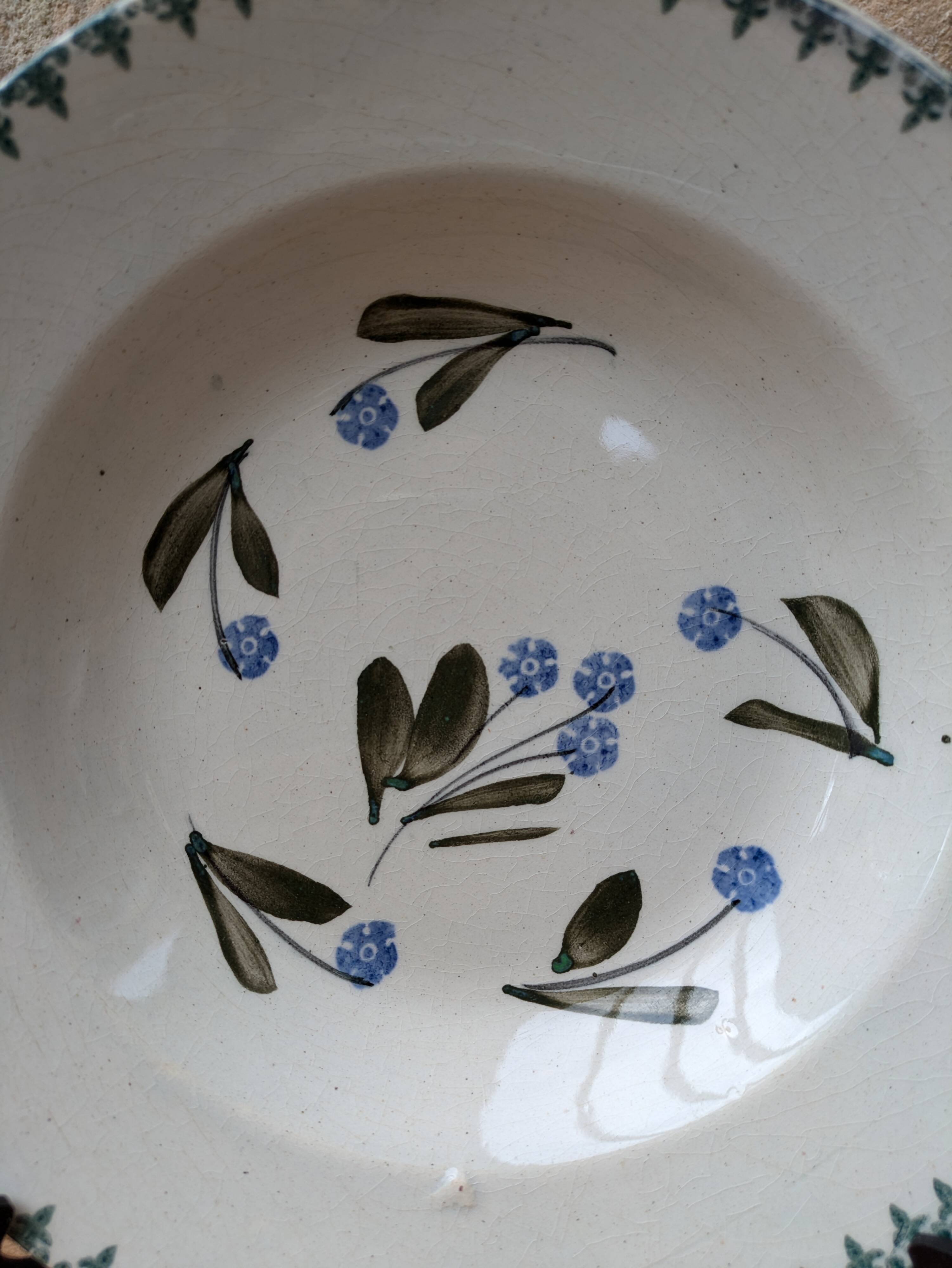 Old deep iron earth plate with blue flower pattern