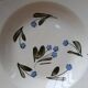 Old deep iron earth plate with blue flower pattern