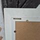 Oval mirror with a distressed white frame