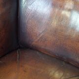 Luxurious sheepskin armchair with a fixed seat cushion and high seating comfort