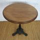 oak tray table with cast iron legs and pair of bistro chairs