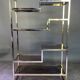 Italian shelf in gold-plated metal and smoked glass