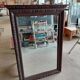 Large bevelled mirror with a carved wooden frame