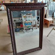Large bevelled mirror with a carved wooden frame