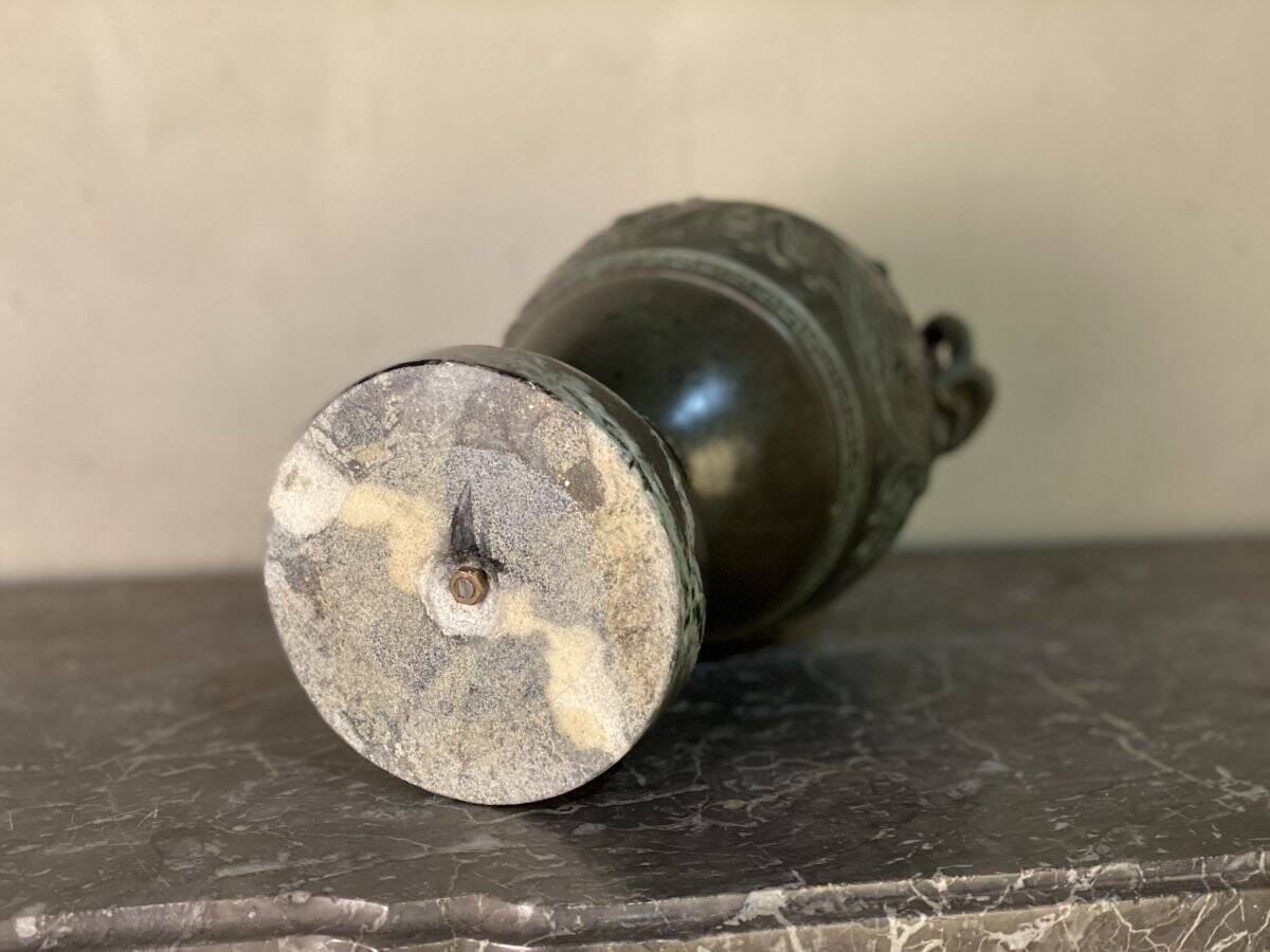 Bronze vase with snakes and a green patina, in the antique style.