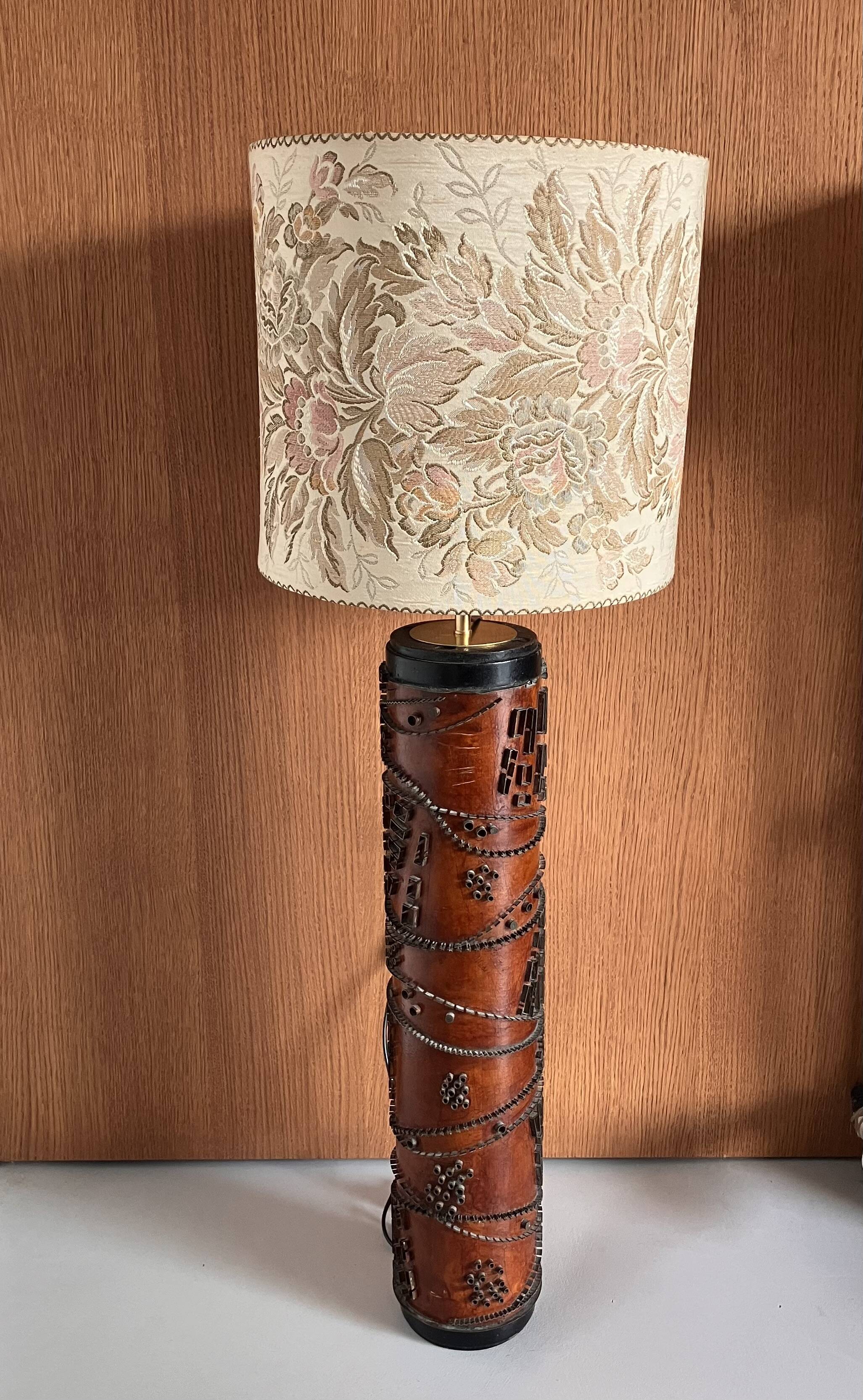 Table lamp with a solid wood printing roll and floral lampshade.