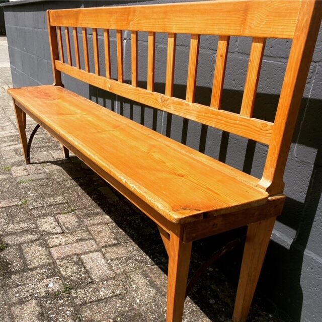 Old wooden long station bench from Belgium